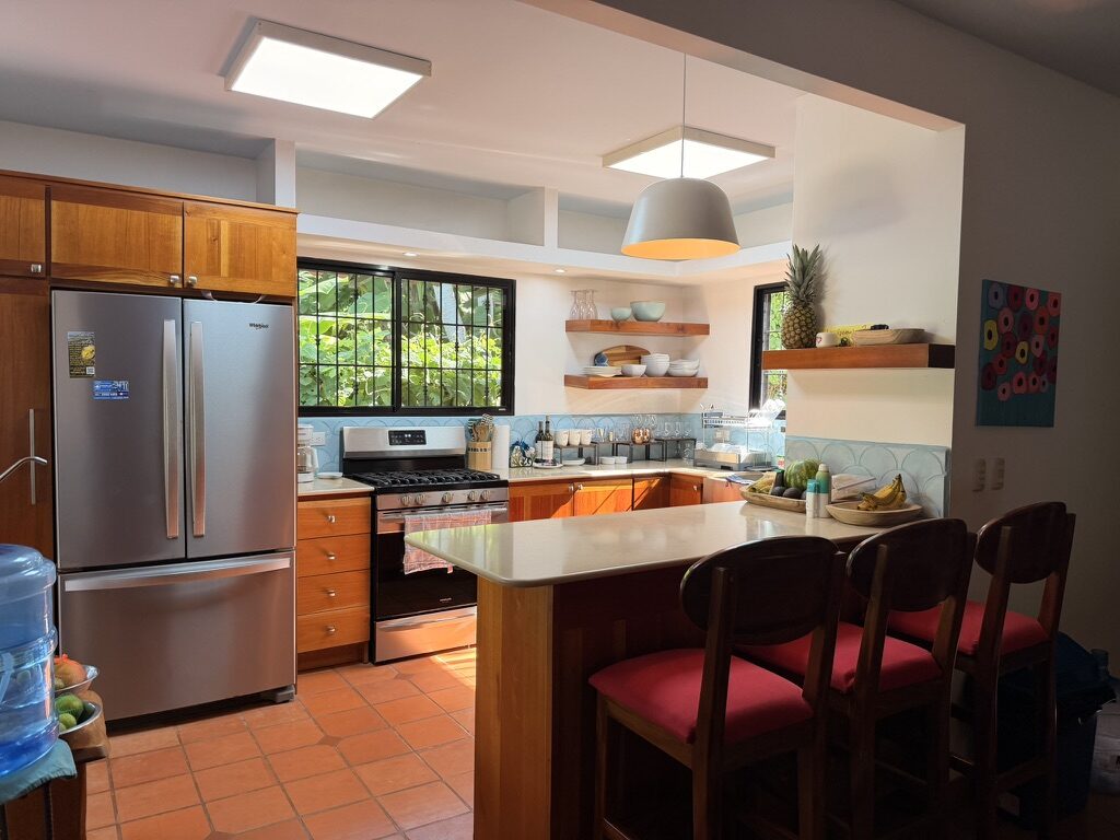 Kitchen with gas range, fridge and breakfast bar