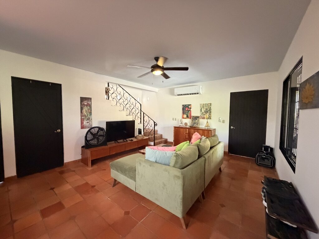 Living room with sectional sofa and air conditioning