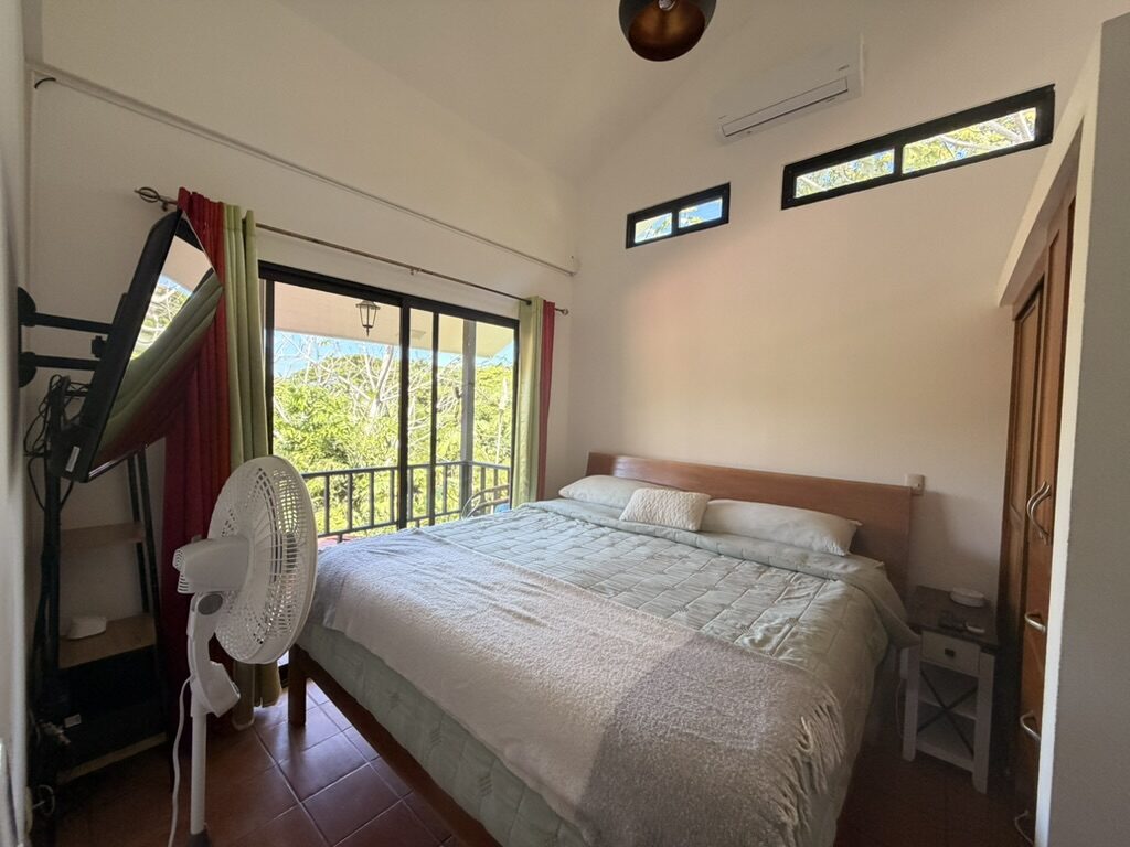 Main bedroom with king bed and balcony door